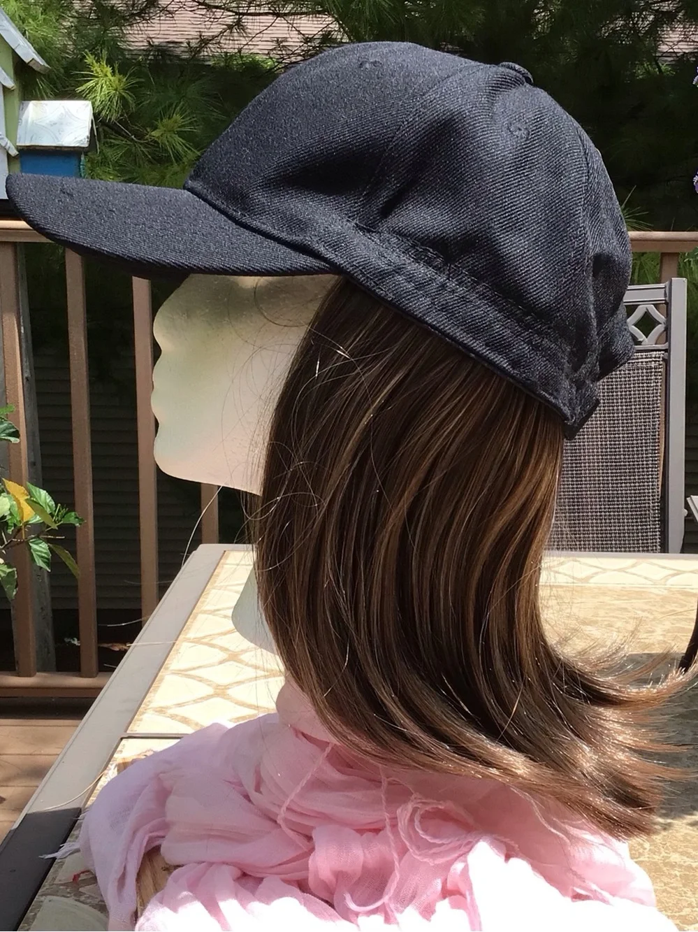 Black baseball cap with brown/blonde highlights attached wig